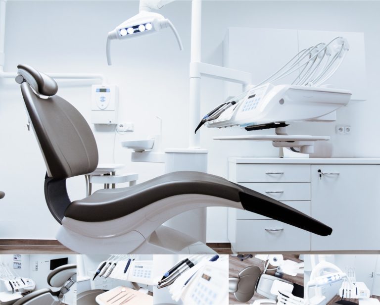 A dental exam chair with an assortment of dental tools below it
