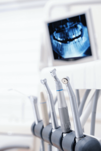 dental tools in front of an x-ray