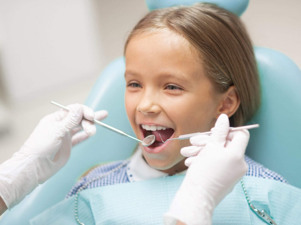 young girl getting a dental checkup